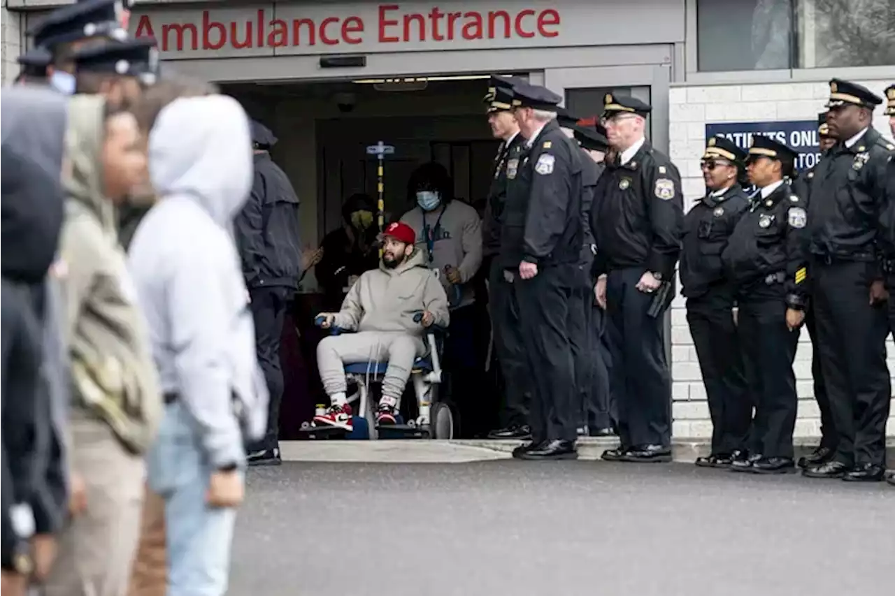 Philly Police officer shot during traffic stop is released to applause after a monthlong hospital stay