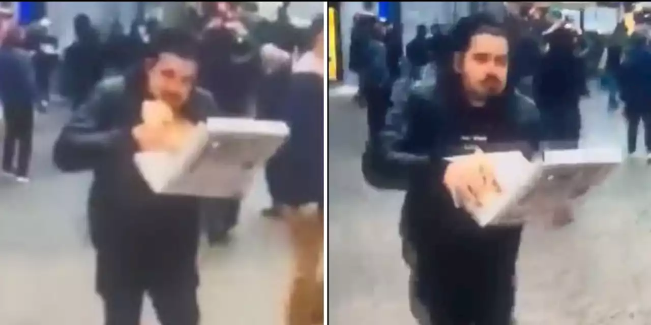 Napoli, mangia la pizza mentre fugge dagli scontri: il video è virale