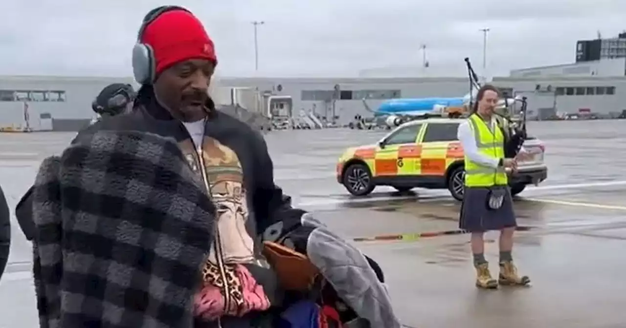 Snoop Dogg dances at Glasgow airport as piper welcomes him to city