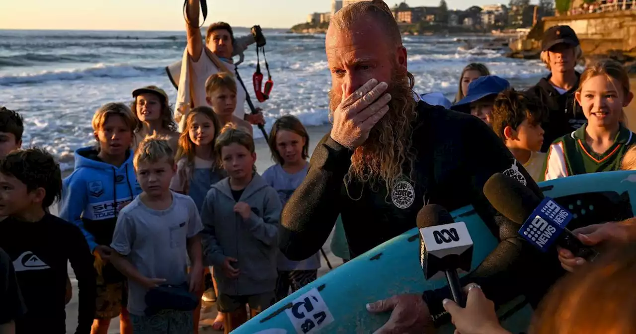 Australian surfs for 40 hours to smash world record, braving pitch-black seas and dodging swarms of jellyfish