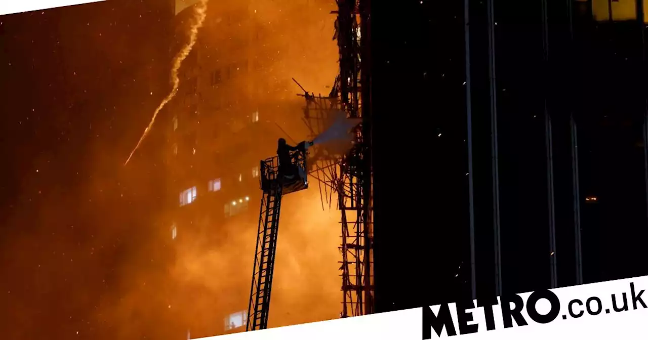 Huge fire tears through Hong Kong skyscraper raining embers on street below