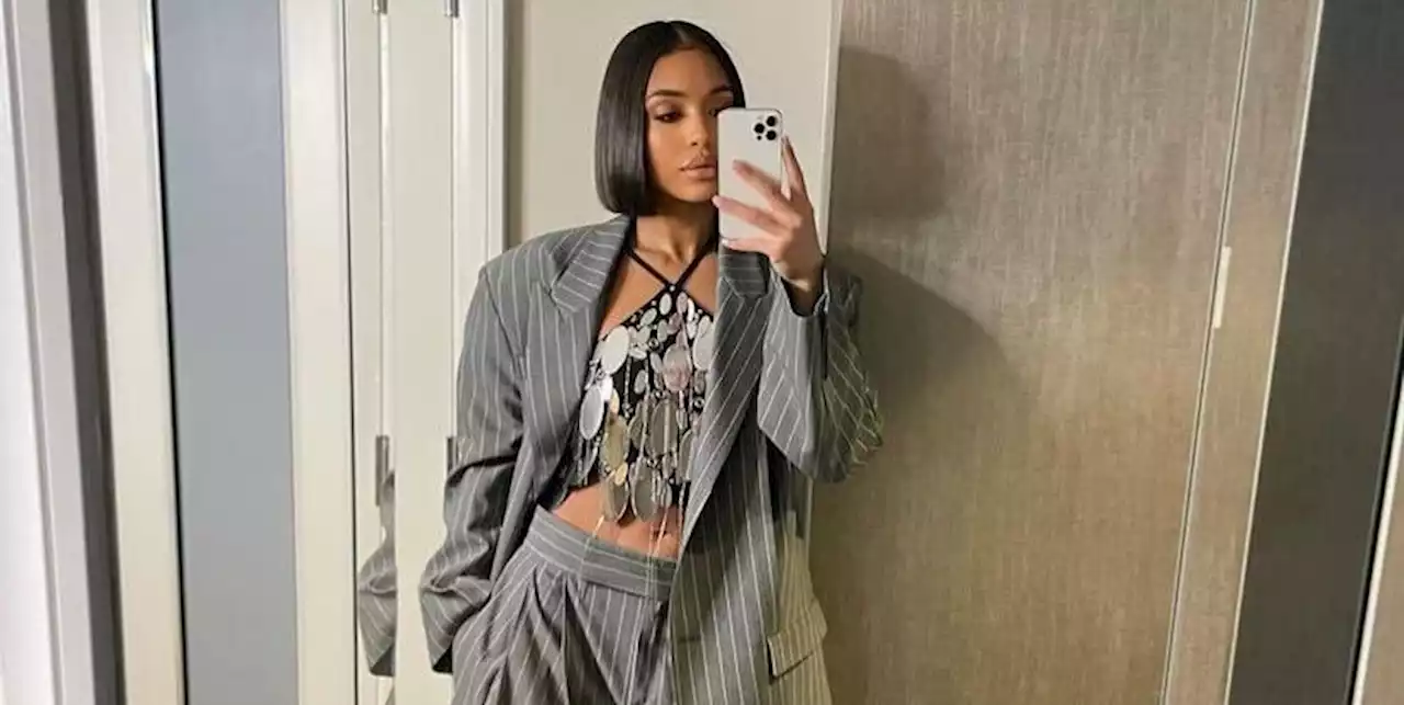 Lori Harvey Styles an Oversized Pinstripe Suit with a Shimmering Halter Top for White House Visit