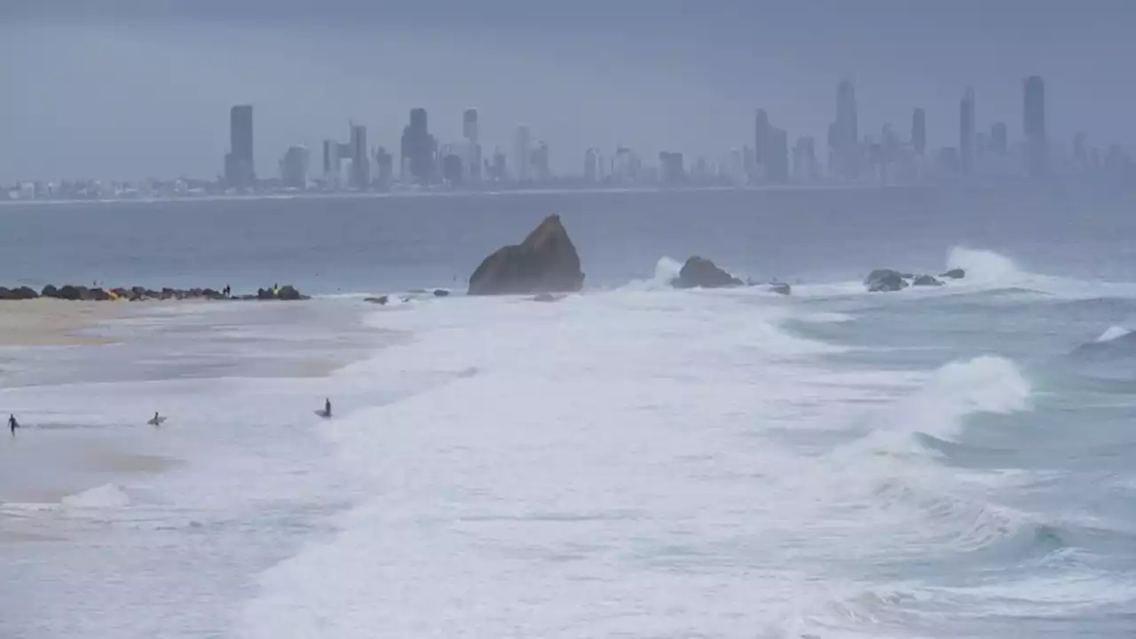 Search underway on Gold Coast after mystery man's report of woman being swept out to sea