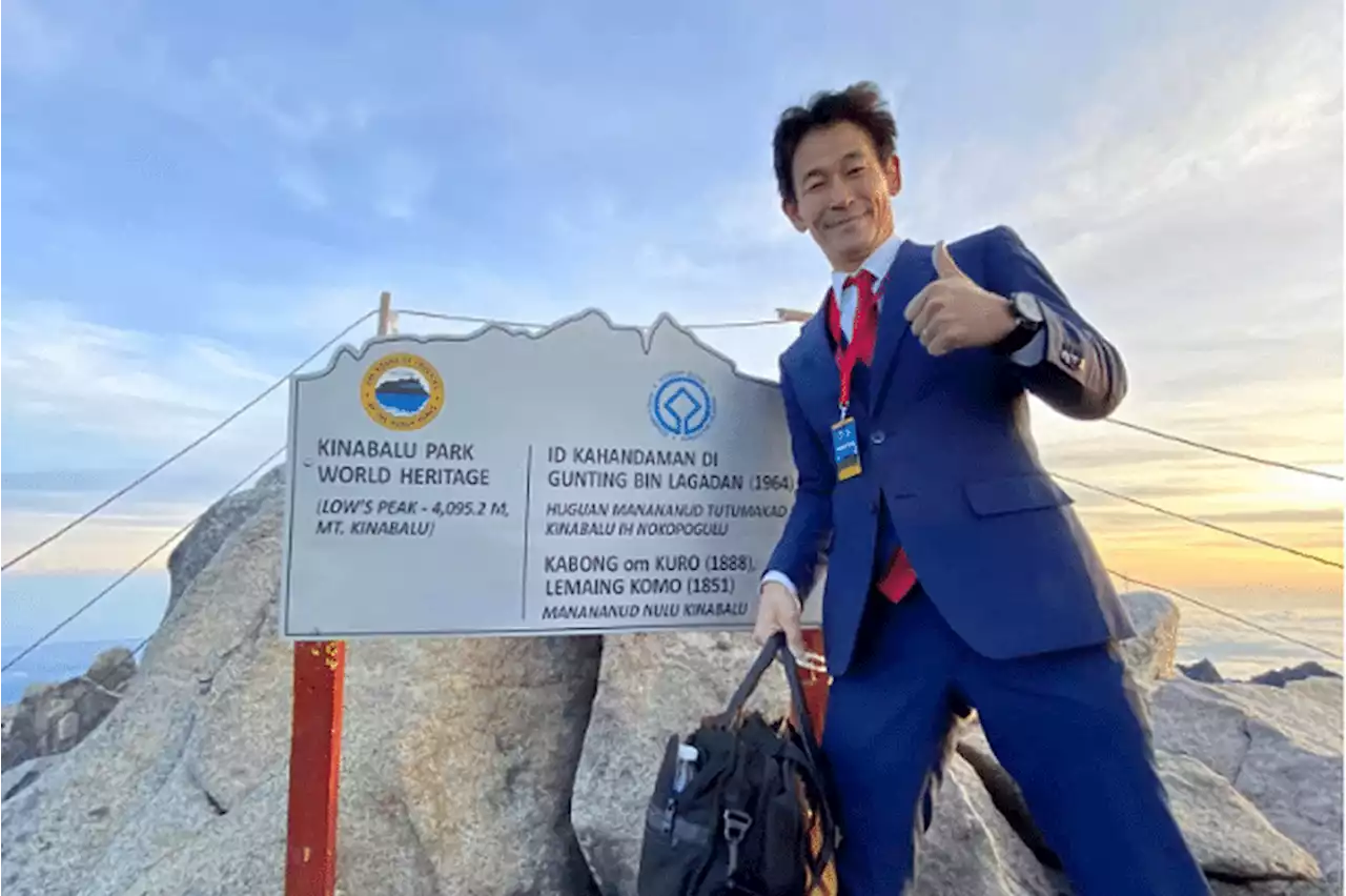 ‘Business meeting’: Japanese tailor scales Mount Kinabalu in three-piece suit, leather shoes