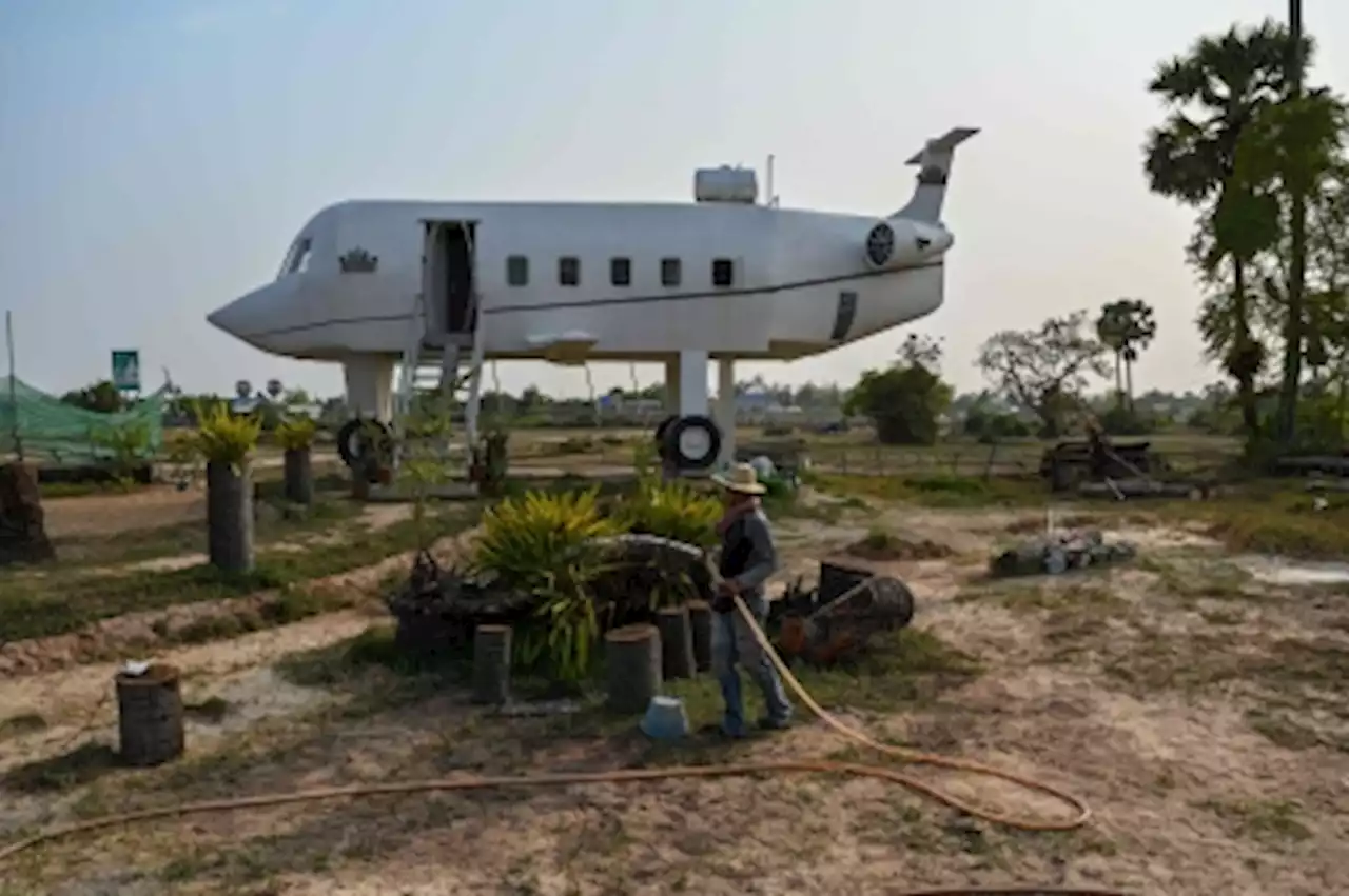 Cambodian man lands ‘airplane’ house in rice field