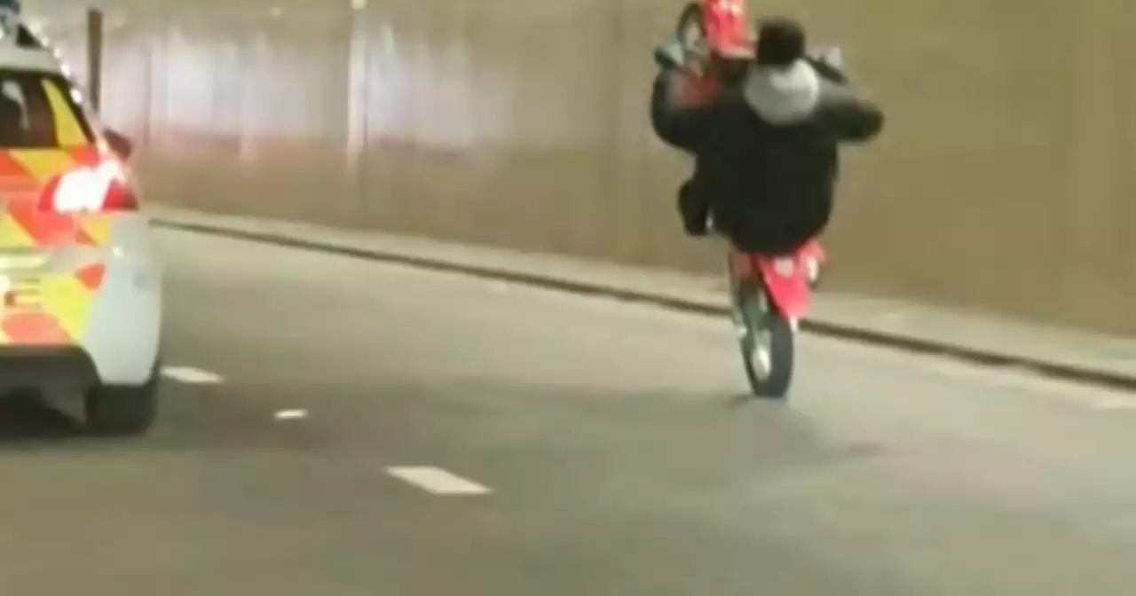 Moment wheelie-pulling biker taunts police on patrol in Leeds