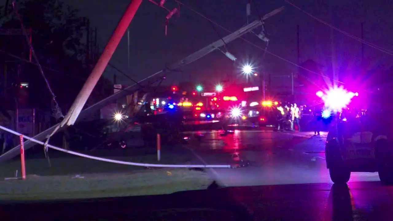 Multiple power poles topple during Harris Co. crash, trapping cars and blocking road