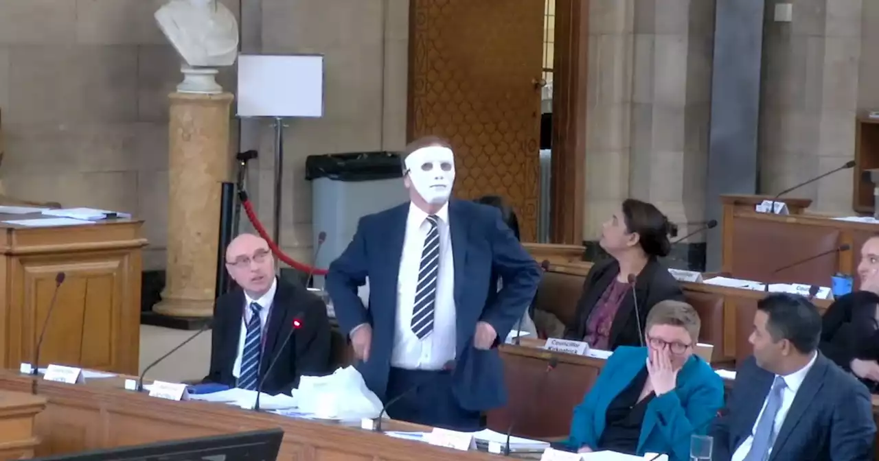 The moment a Manchester councillor put on faceless mask at a town hall meeting