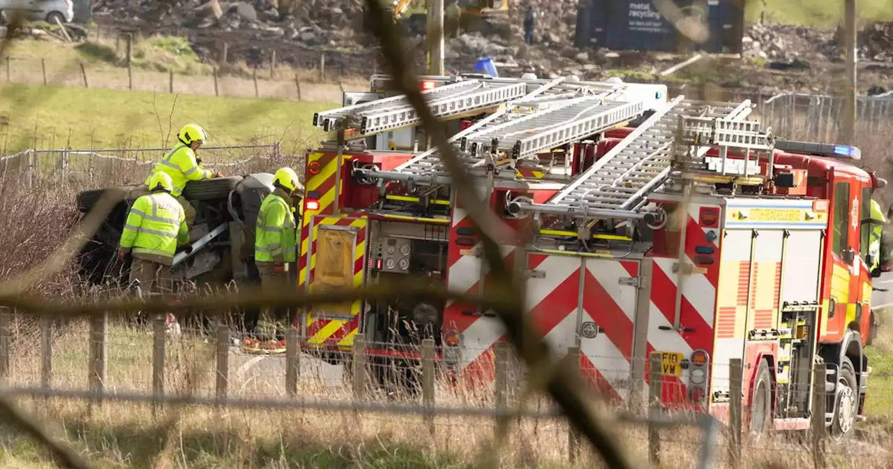 Car flips onto side on Scots road as emergency services rush to scene