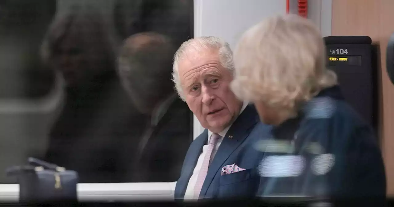 King Charles and Camilla look deep in conversation as they take train to Hamburg