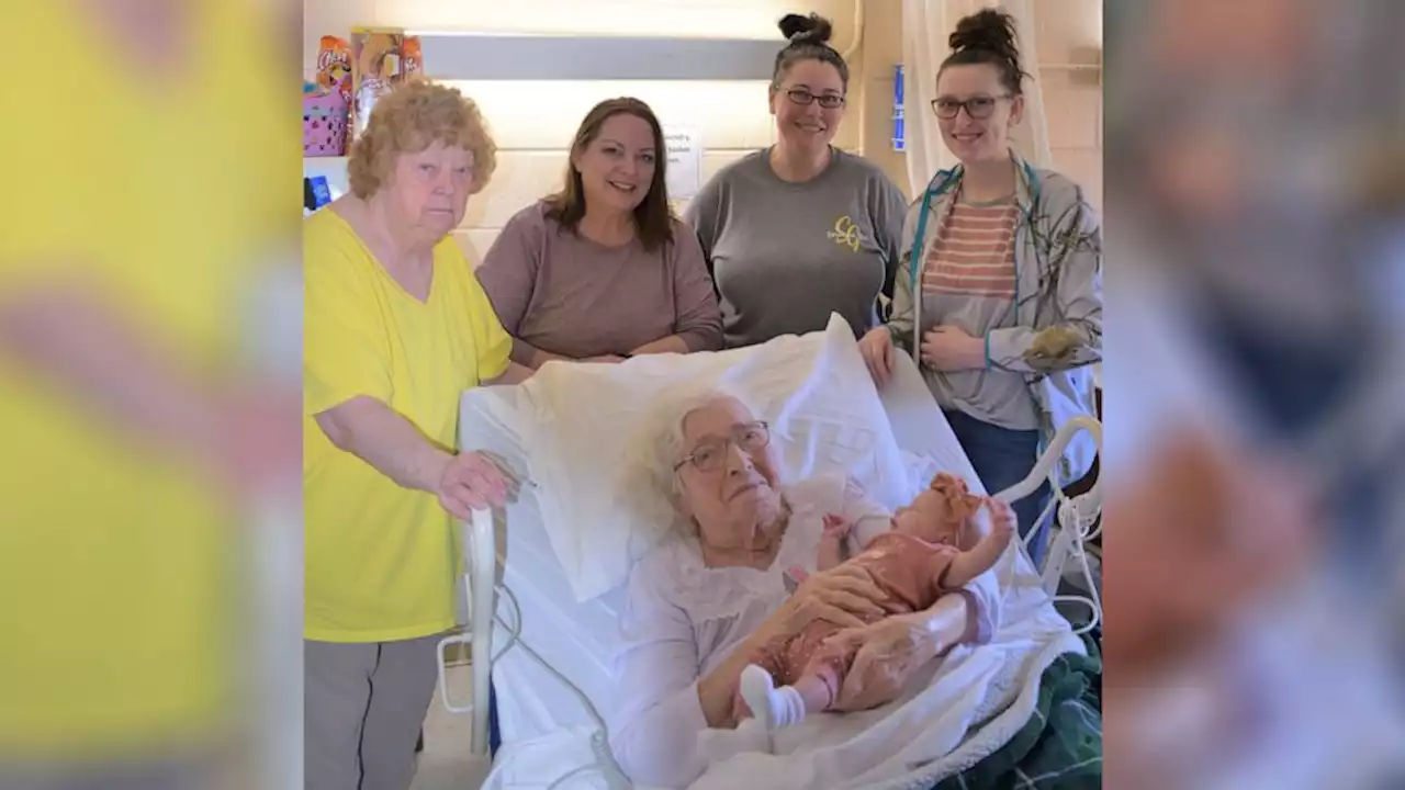 Six generations of the same family pose together with newborn