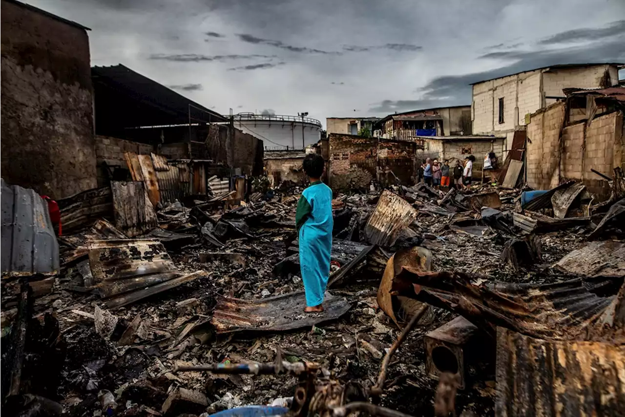 Indonesians search charred homes after fuel depot fire kills 18