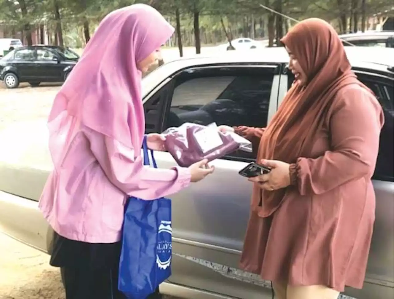 Graduan UiTM agih tudung secara percuma