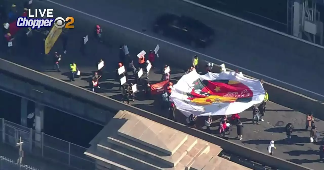 'Excluded workers' march across Manhattan Bridge calling for unemployment funds