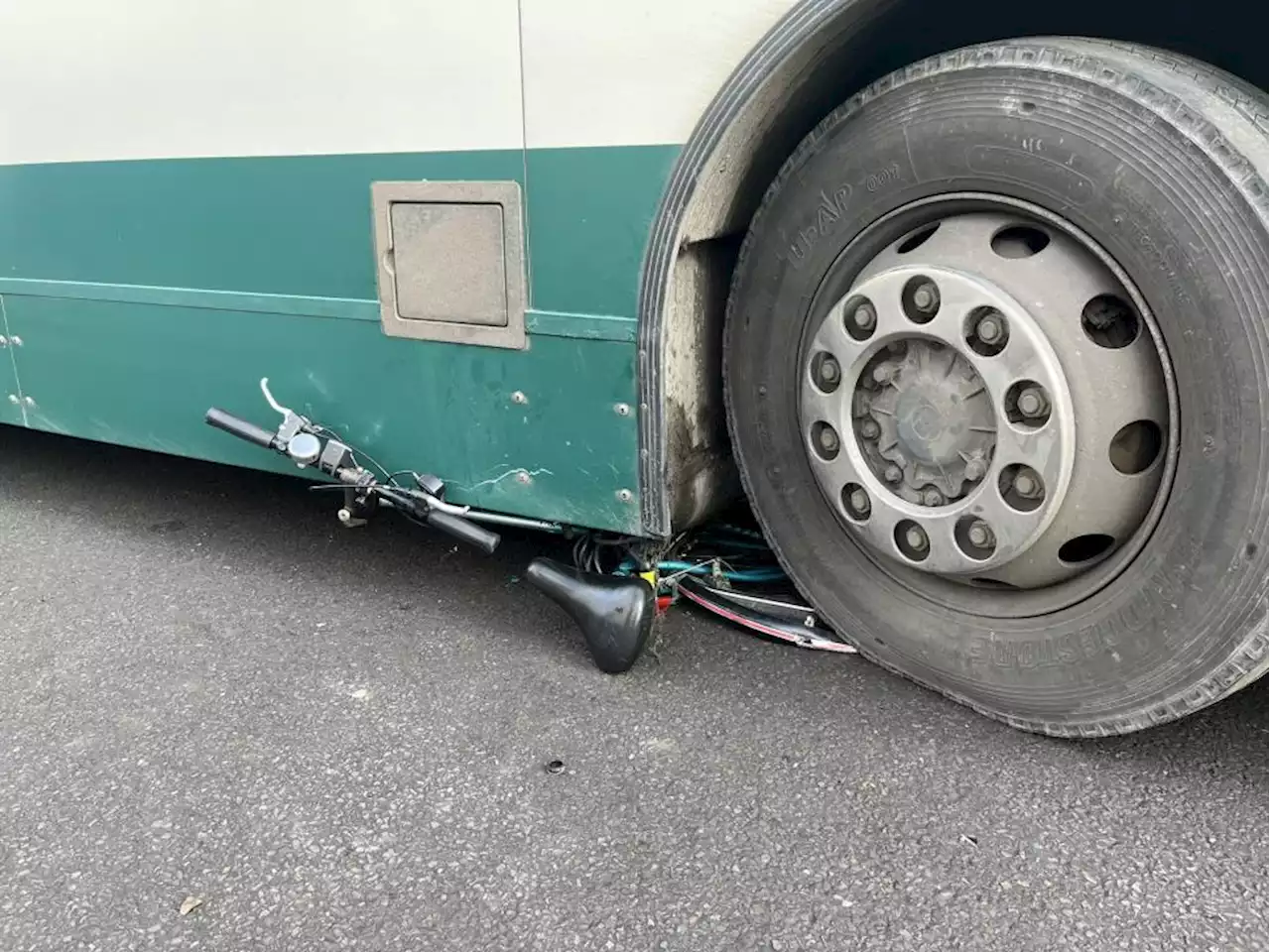 Cyclist suffers serious injuries in collision as bike pictured crushed under bus