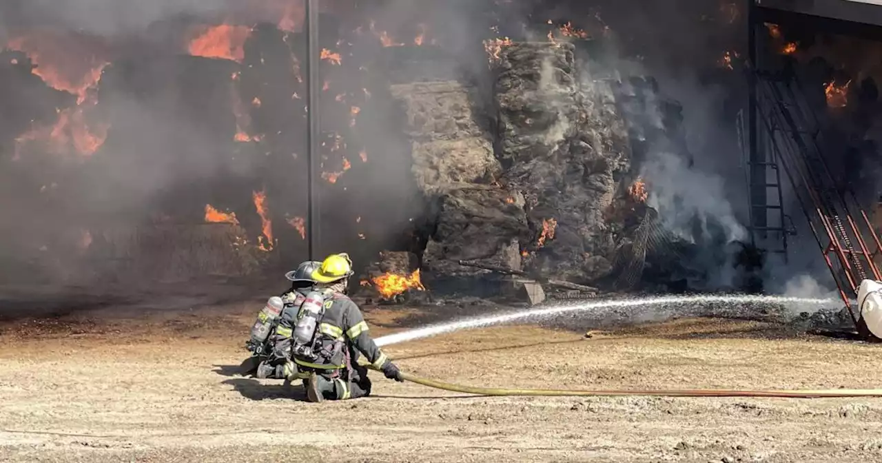 Firefighters working to extinguish a large barn fire near Mead