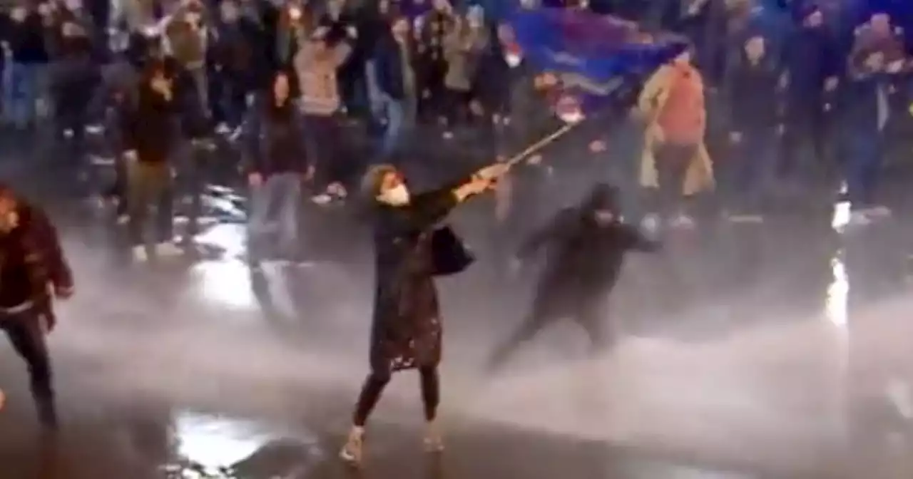 Watch This 'Iconic' Clip Of Woman Defying All Odds To Protest 'Russian' Bill In Georgia