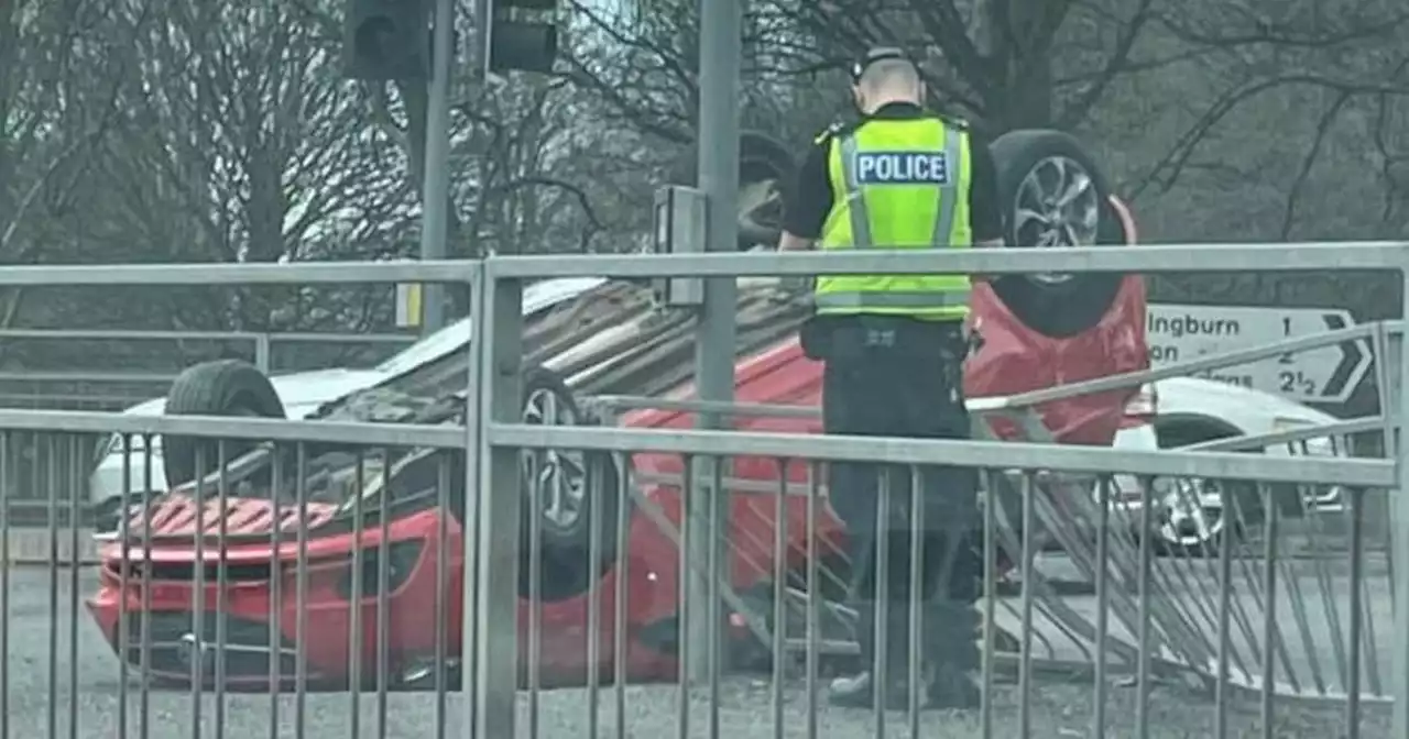 Car overturns on busy Glasgow road and smashes into metal railings near Tesco