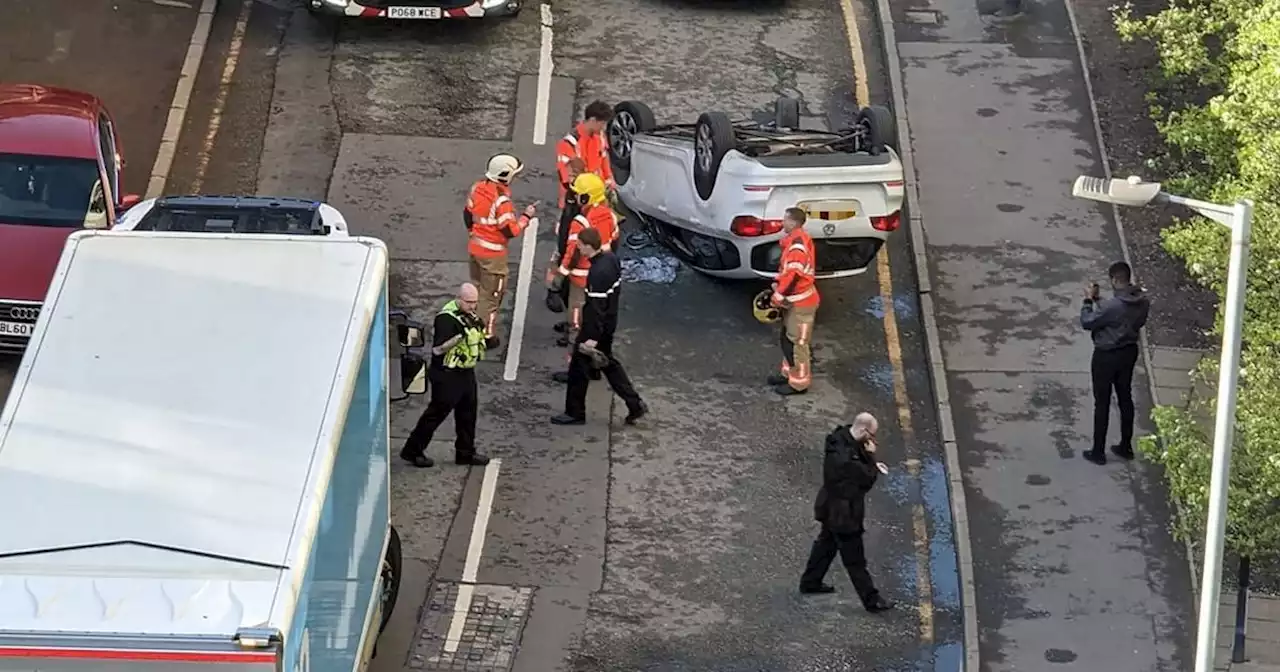 Mercedes flips onto roof in city centre crash as fire crews race to scene