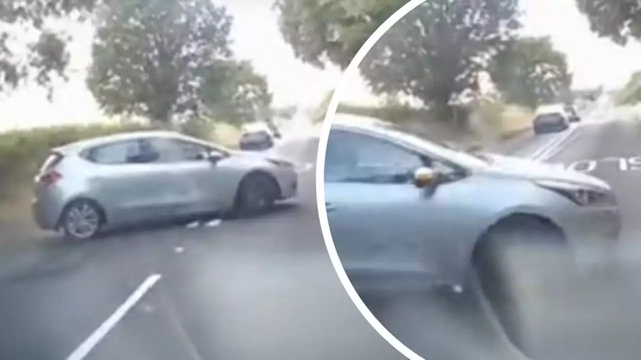 Shocking moment driver smashes into car while doing three-point turn in road