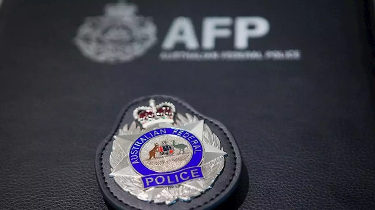 Australian Federal Police quit using controversial spit hoods in ACT after review finds risks cannot be justified