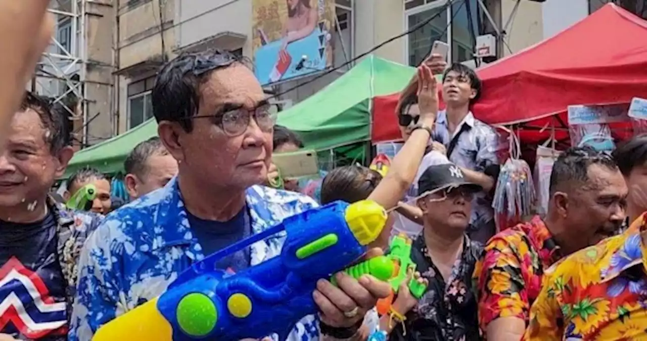 Thai PM gets a drenching in surprise water fight appearance