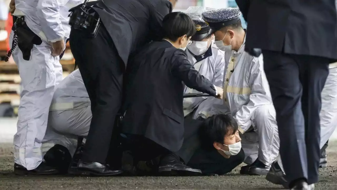 Japanese suspect throws smoke bomb at prime minister, gets tackled on video