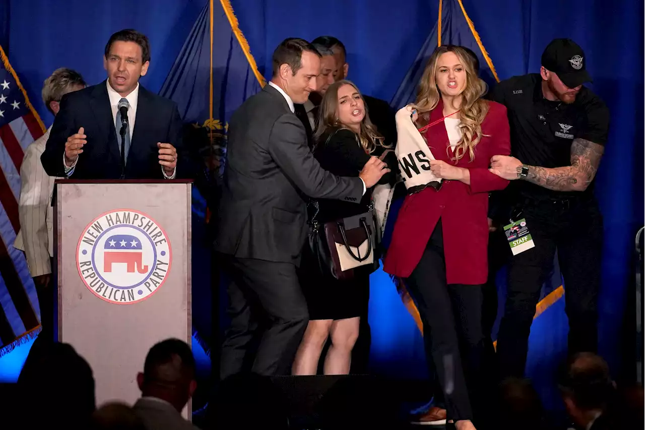 Two protesters storm stage during DeSantis speech in New Hampshire