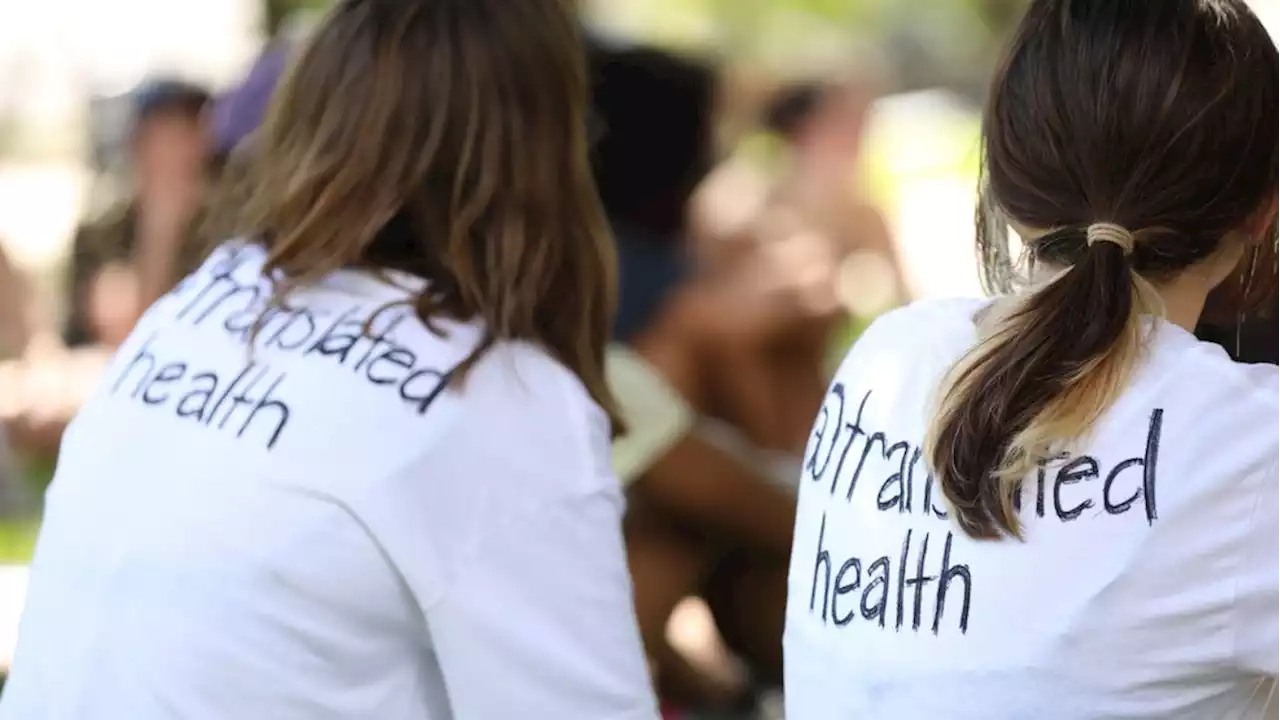 UT Students and community leaders march to the Texas capitol highlighting global health.