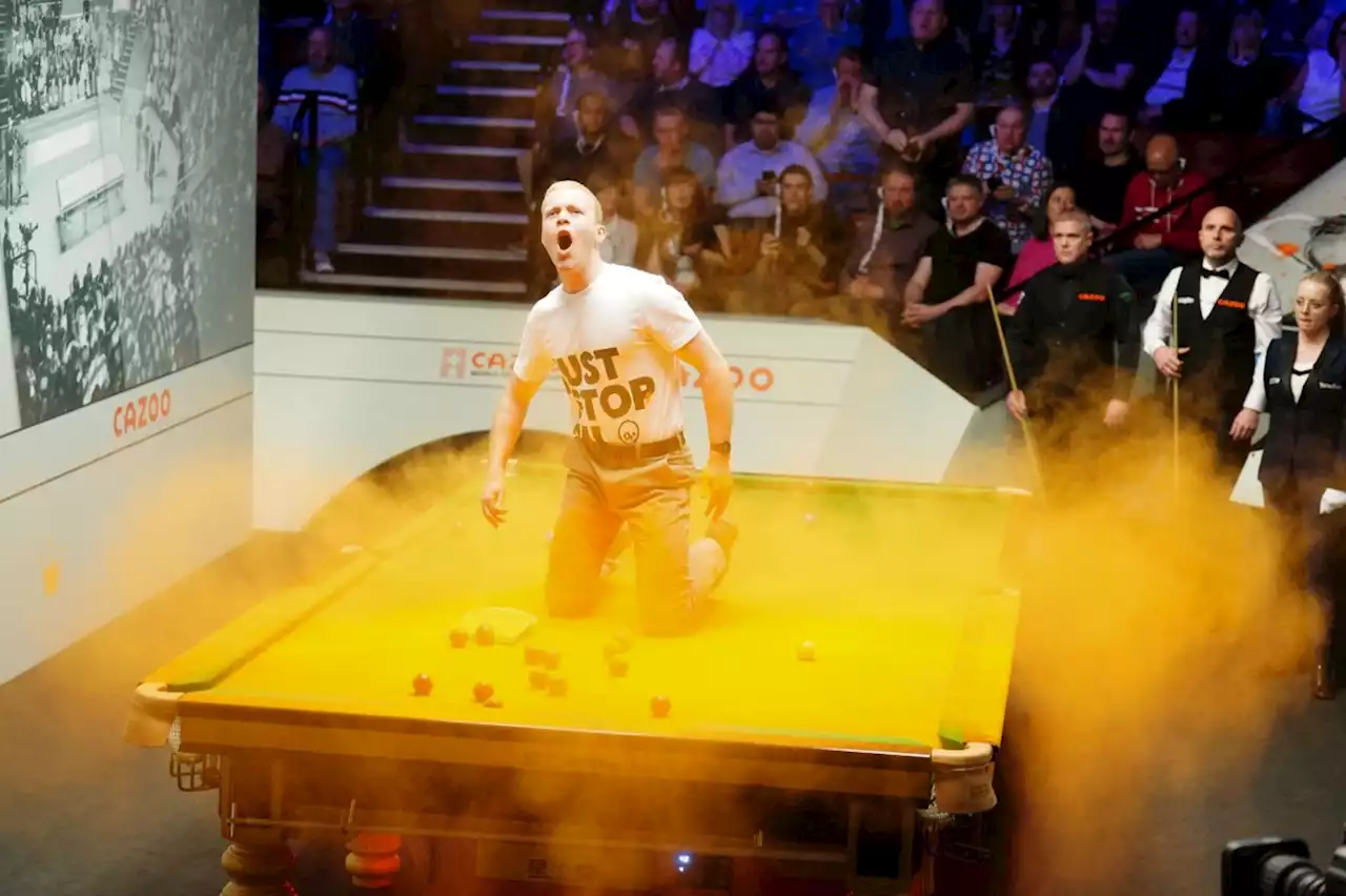 Just Stop Oil protesters disrupt World Snooker Championship by throwing paint on table