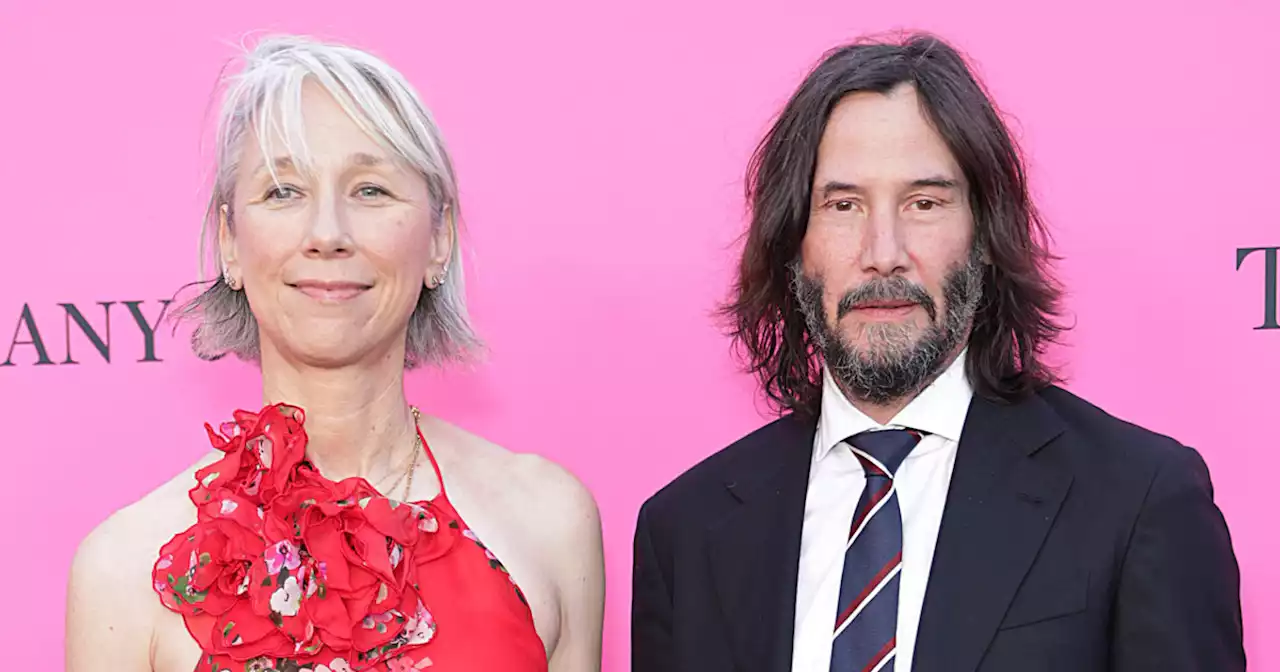 Keanu Reeves shares a kiss with Alexandra Grant during rare red carpet appearance together