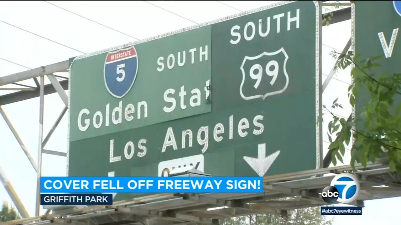 Sign for 5 Freeway falls down near Griffith Park, revealing old Highway 99 sign from 1960s