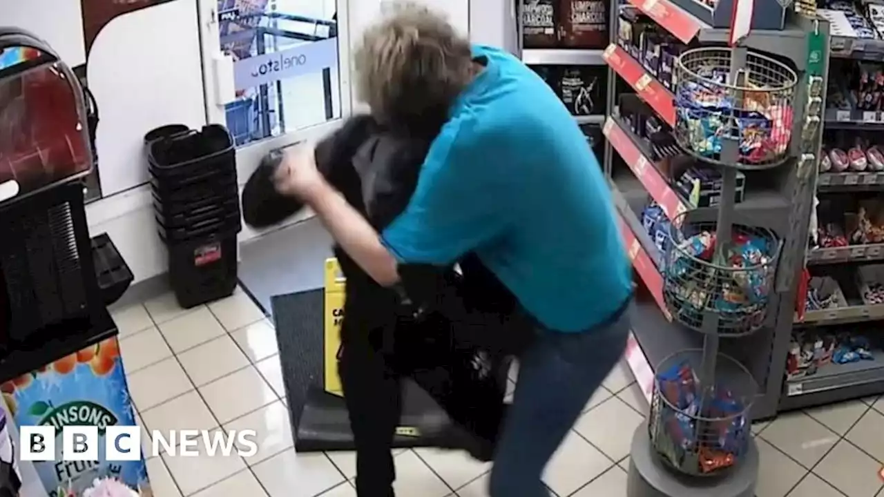 Moment shop worker wrestles gun-wielding robber