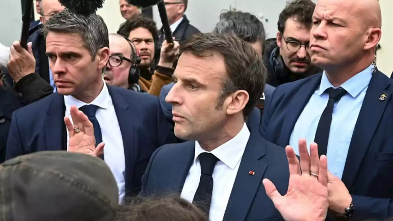 Macron booed by angry French after signing pensions reform