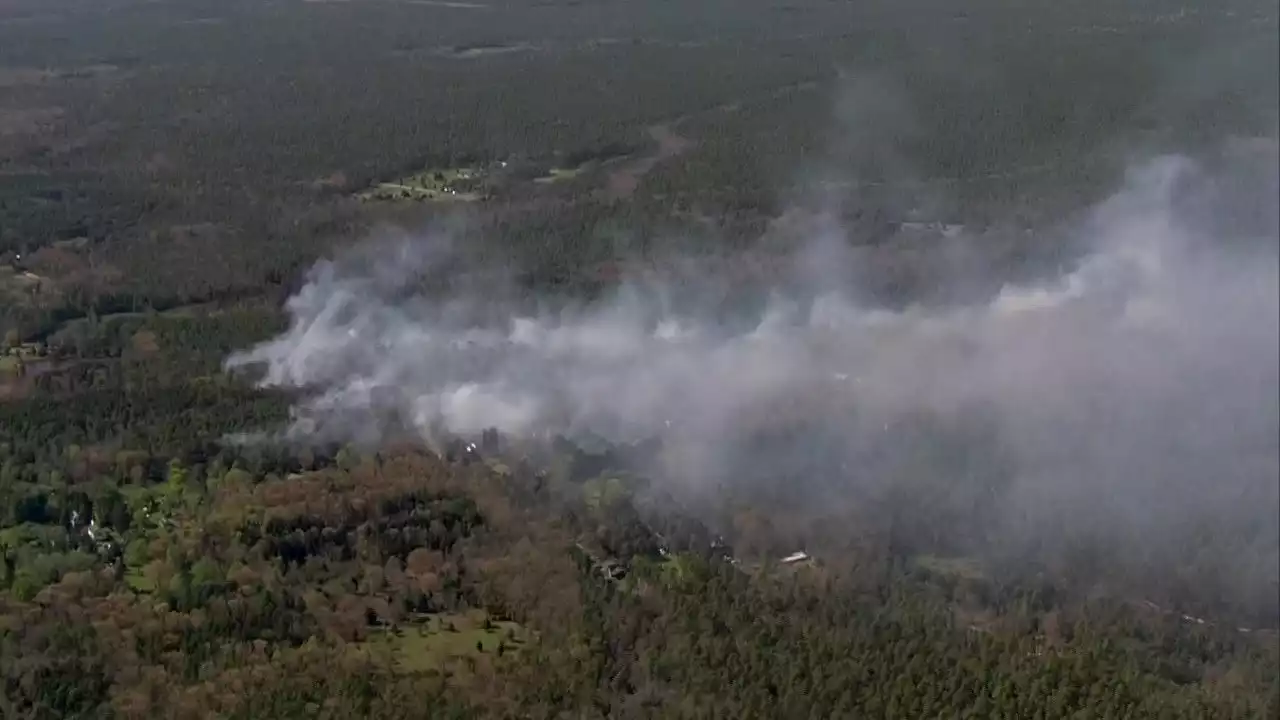 Over two dozen structures threatened by uncontained wildfire in Washington Township