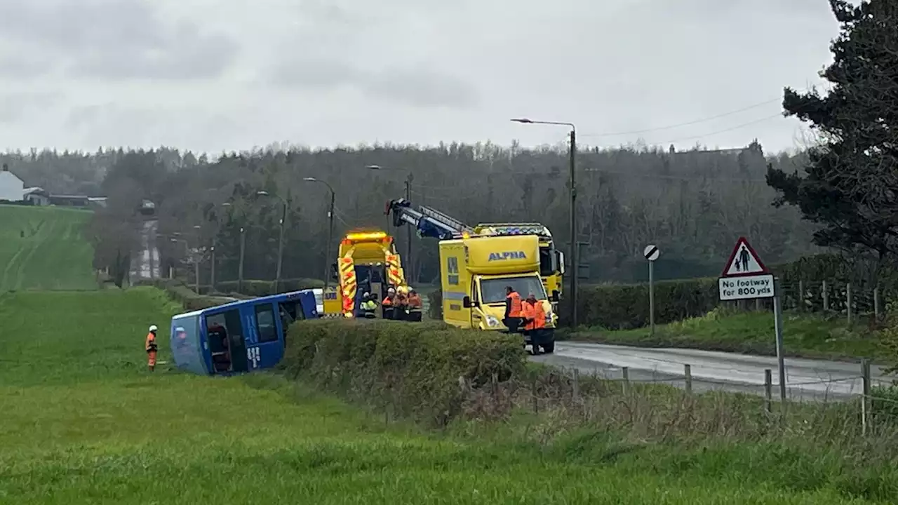 Four taken to hospital after double-decker bus crashes and overturns in field in County Durham