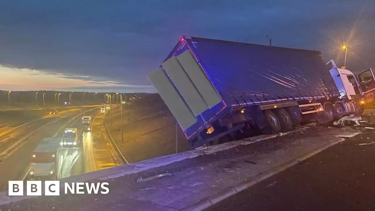 M1 and A14 closures after crash that left lorry hanging off bridge