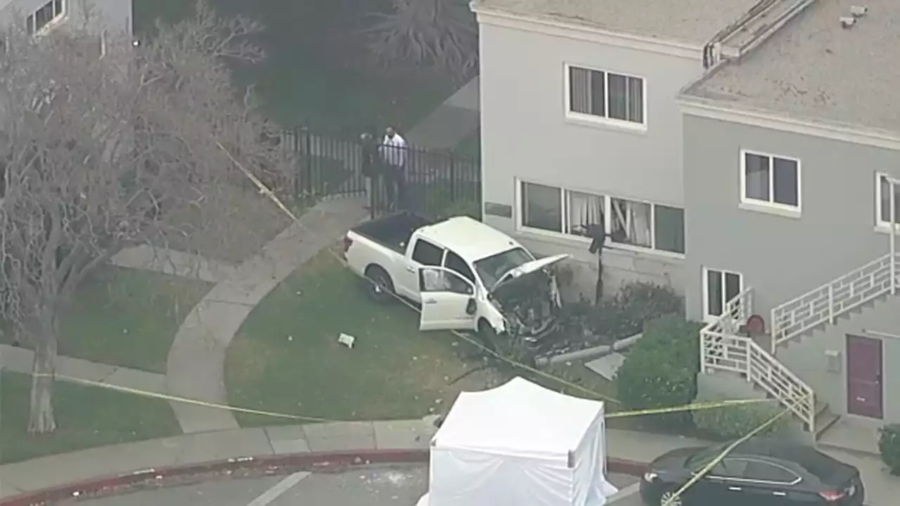 Adult pedestrian killed, child hurt before pickup truck slams into Mid-Wilshire apartment building