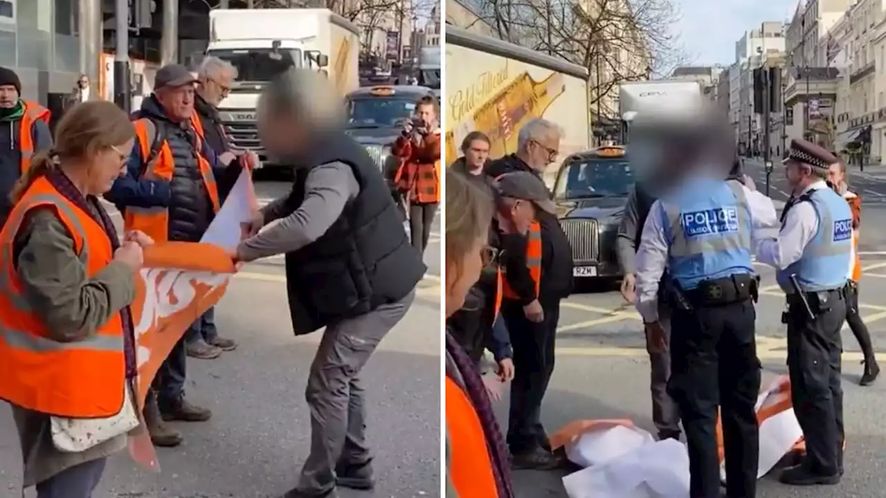 Angry driver who confronts eco-protesters blocking the road and snatches their banner gets told off by police himself