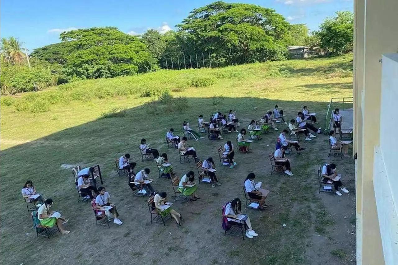 Teacher in the Philippines holds class outdoors, as school bakes amid heatwave