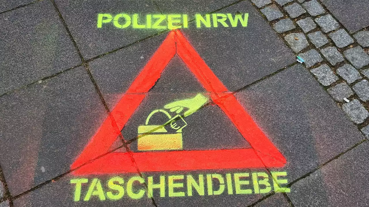 Piktogramme gegen Taschendiebe in Köln