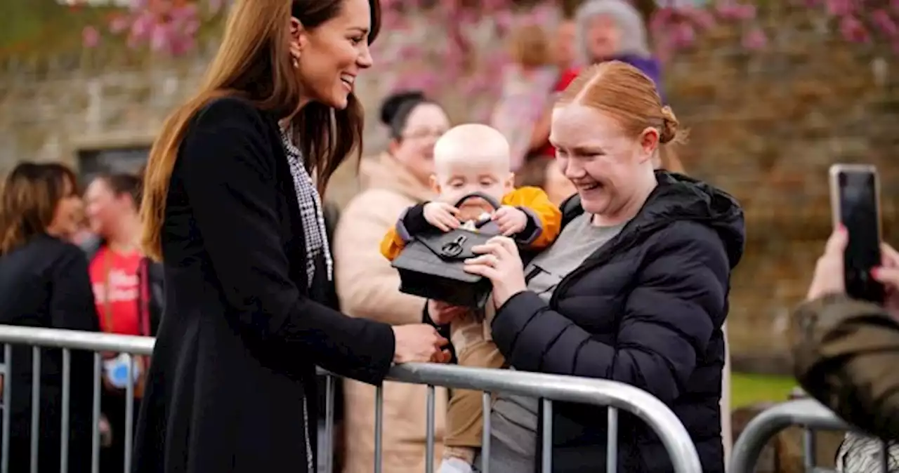 Cheeky baby snatches handbag from British royal Kate