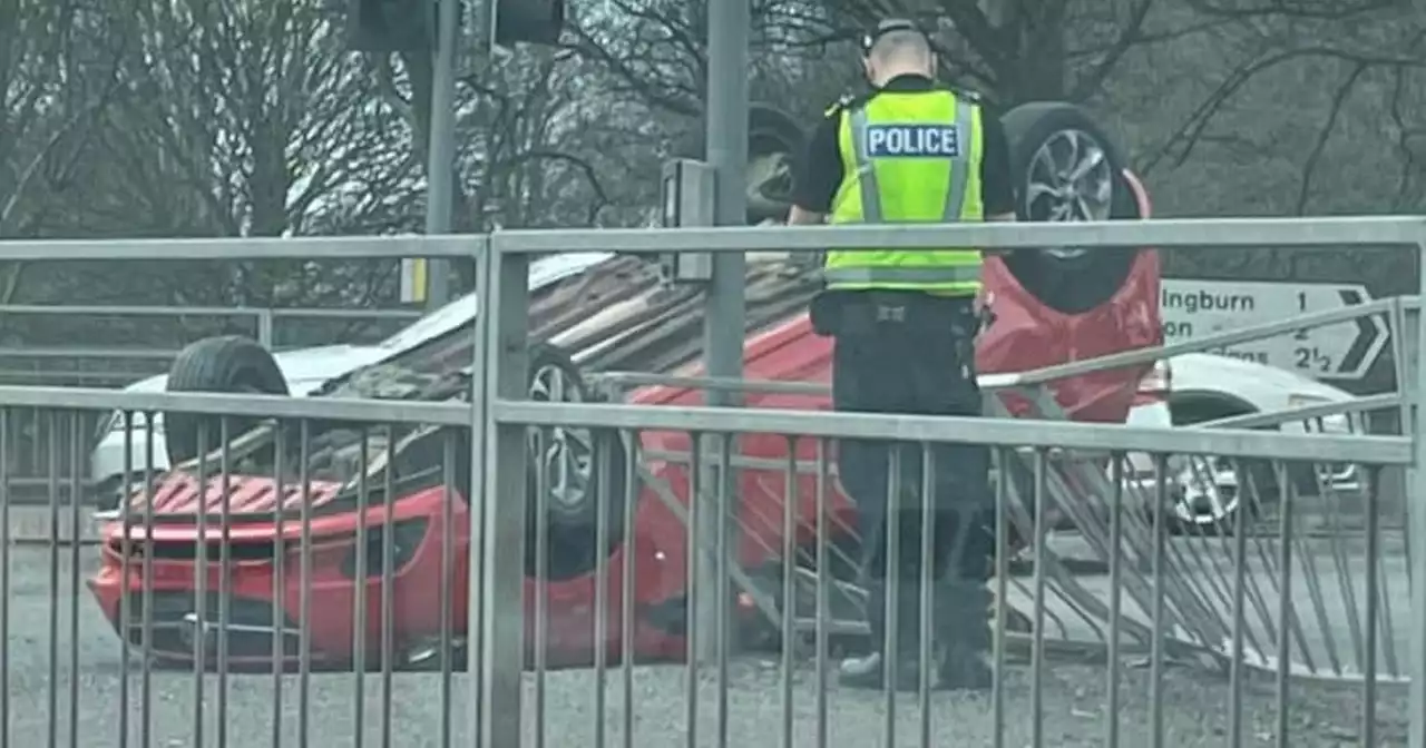 Car flips onto roof after crash on busy Glasgow road as woman charged