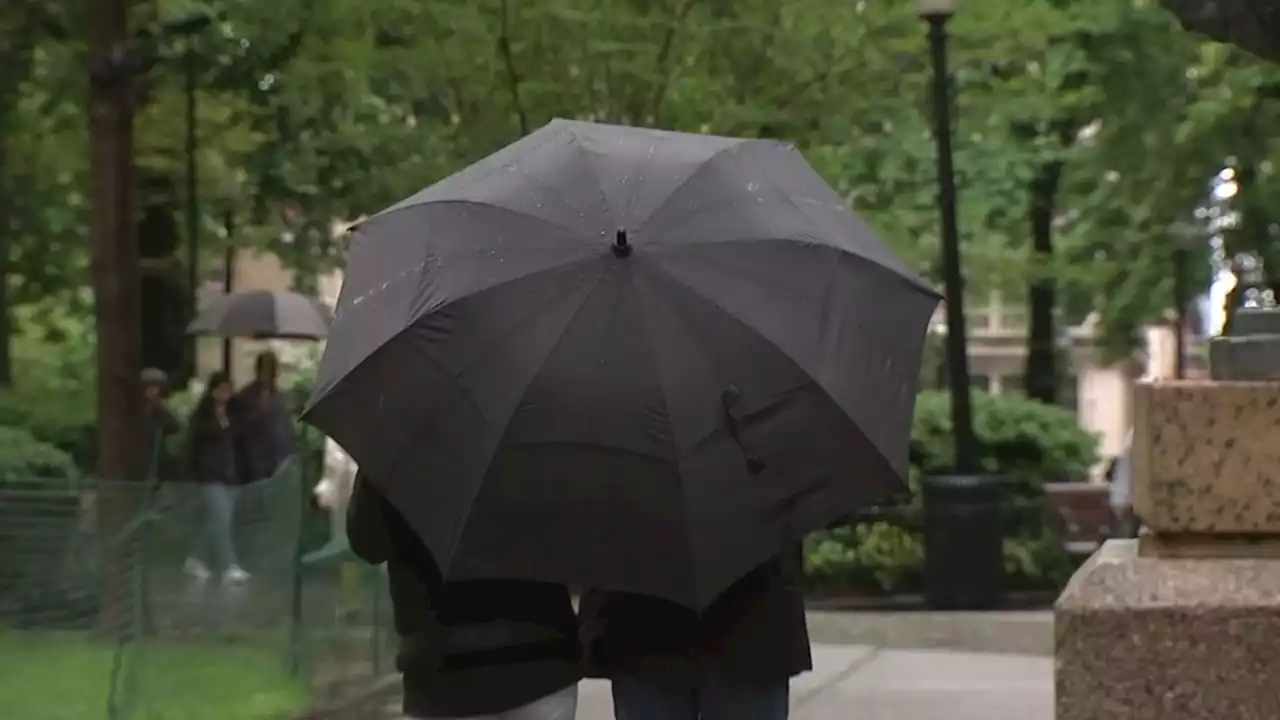 Philadelphians enjoy rainy Sunday afternoon in Rittenhouse Square, running errands