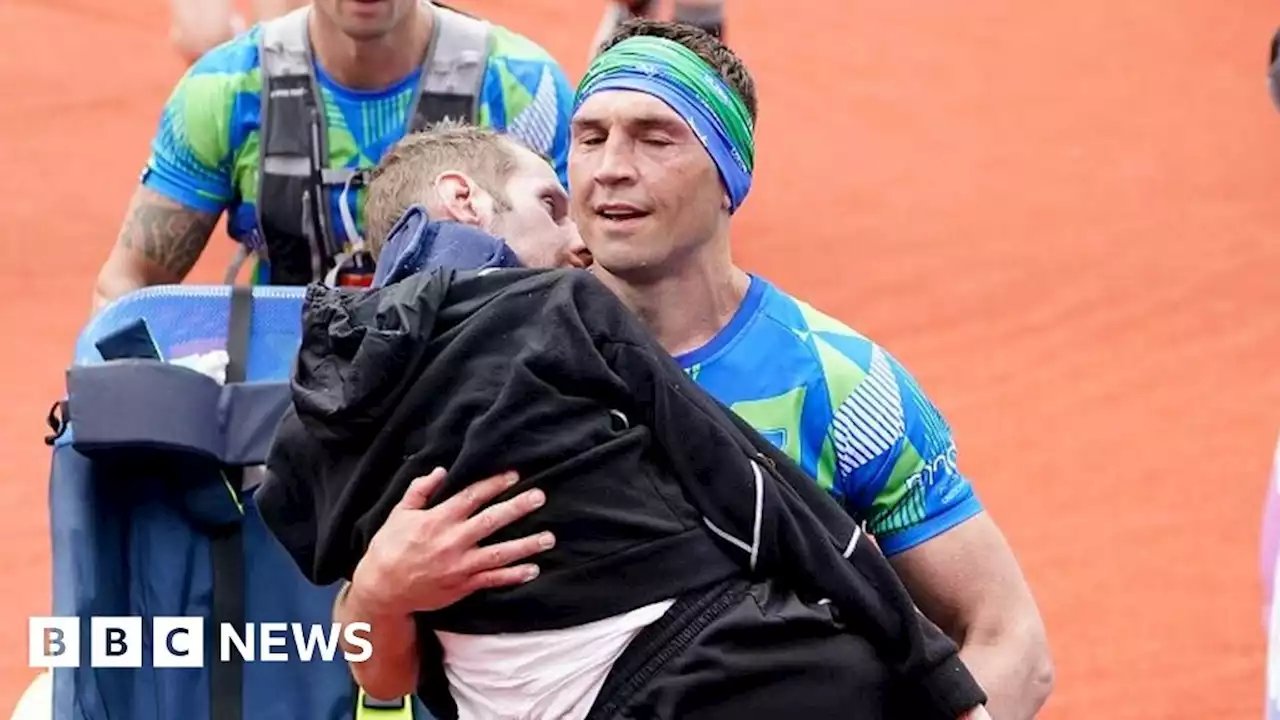 Kevin Sinfield carries Rob Burrow at Leeds marathon finish