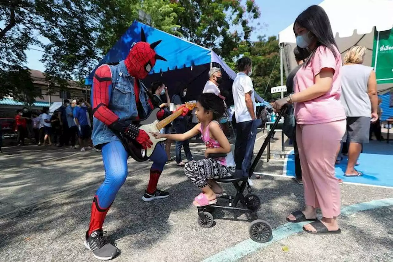 Thai election: Voters turn out in droves, some wearing wedding attire, cannabis print, even a box