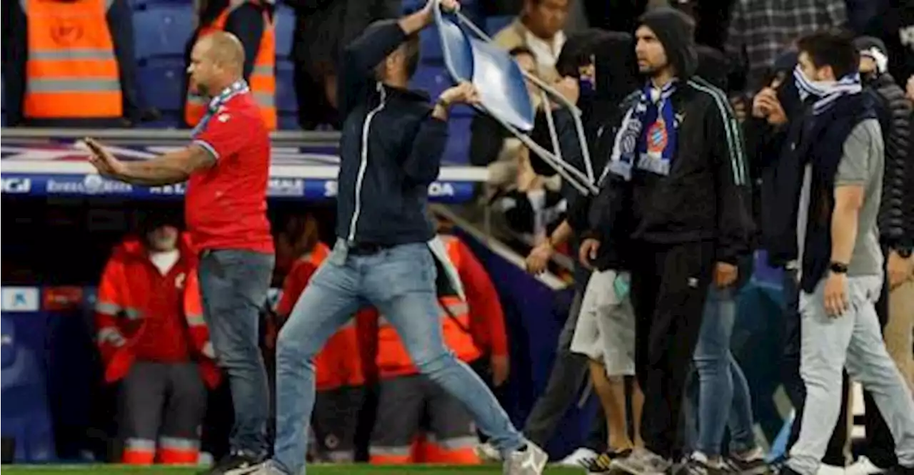 Espanyol fan invades the pitch and throws a chair after FC Barcelona players celebrate winning LaLiga