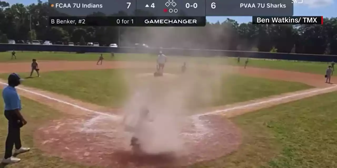 WATCH: Dust devil whirls around young catcher