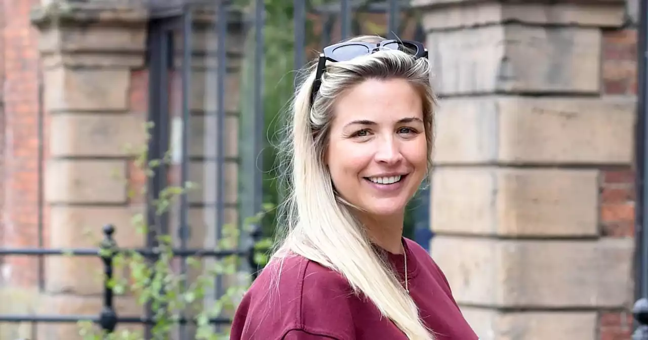 Pregnant Gemma Atkinson smiles on her way to final day at work before due date