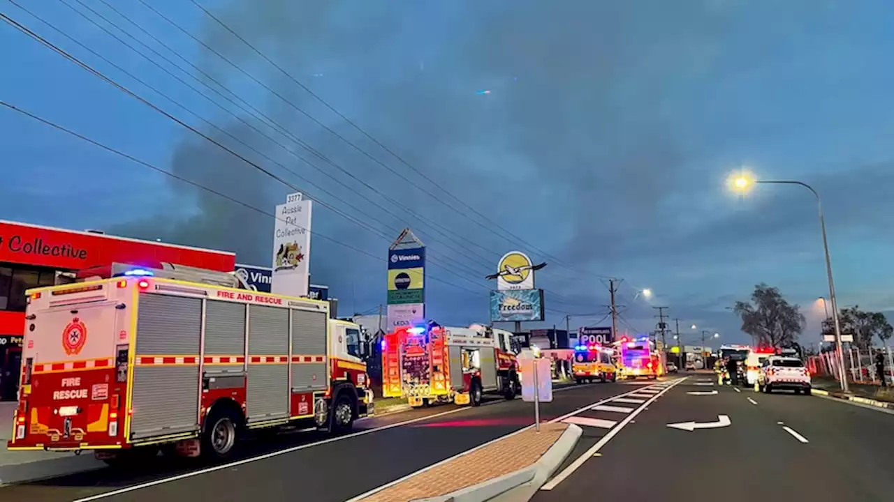 Firefighter revived with CPR at factory fire south of Brisbane, two others taken to hospital